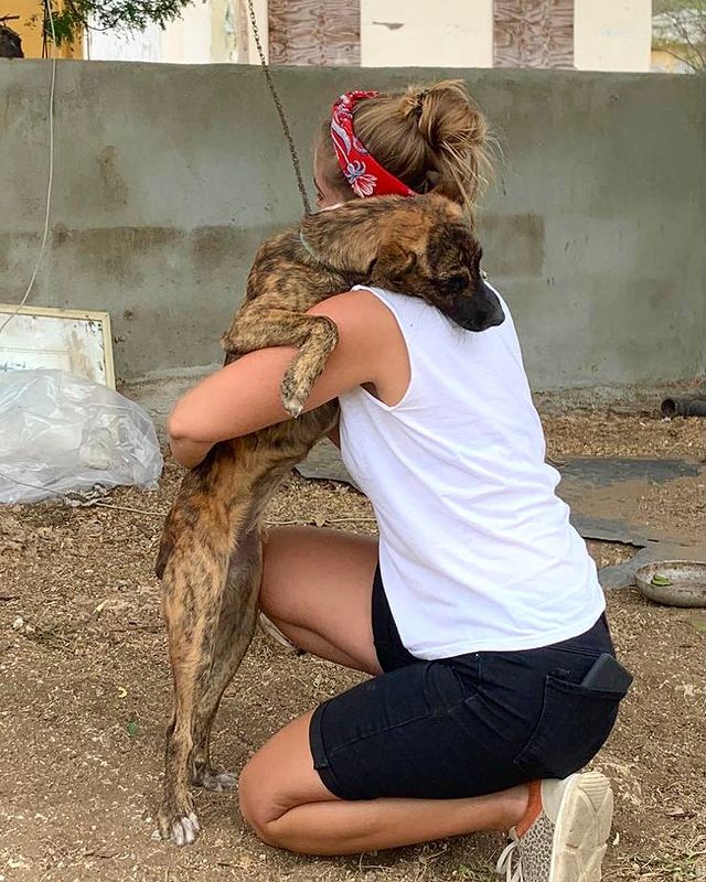 women hugging puppy
