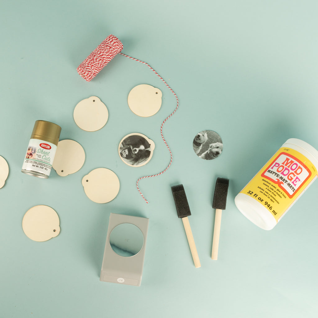 Flatlay of items needed for ornament DIY on blue background