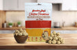 Grandma Lucy's Chicken Parmesan Meatball dog treat bag displayed on a kitchen counter alongside a bowl filled with meatballs.