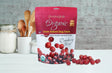 Organic oven-baked cranberry dog treats by Grandma Lucy's displayed on a kitchen counter, showcasing their all-natural ingredients.