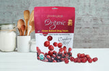 Organic oven-baked cranberry dog treats by Grandma Lucy's displayed on a kitchen counter, showcasing their all-natural ingredients.