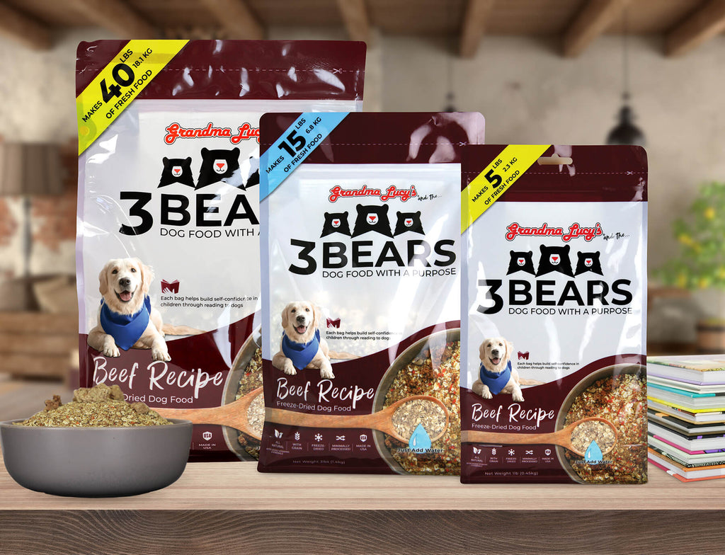 Three sizes of Grandma Lucy's freeze-dried 3 Bears beef dog food bags displayed on a wooden kitchen countertop.